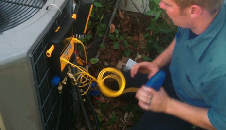 Man maintaining an AC unit