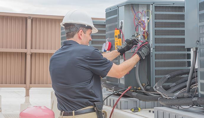 Person repairing air conditioner with equipment