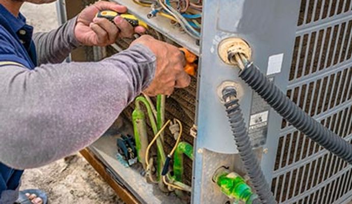 Professional worker repairing and maintaining an HVAC system