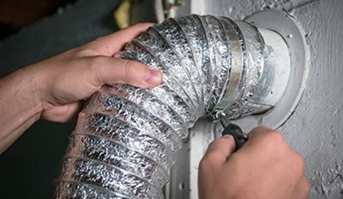 Person installing a flexible dryer vent duct