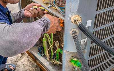 worker repairing & maintaining HVAC