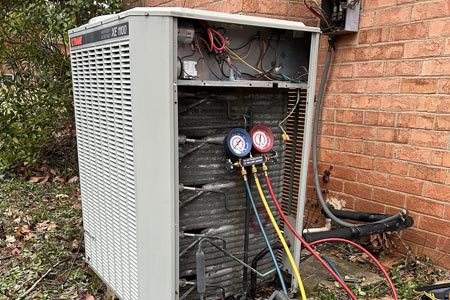 HVAC technician running diagnostics on Trane AC unit HVAC technician running diagnostics on Trane AC unit