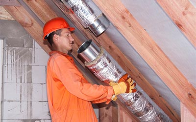 Worker installing duct