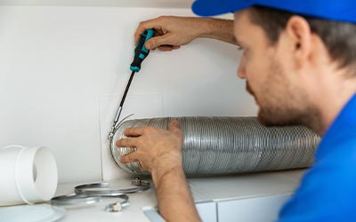 Professional worker installing ventilation tube